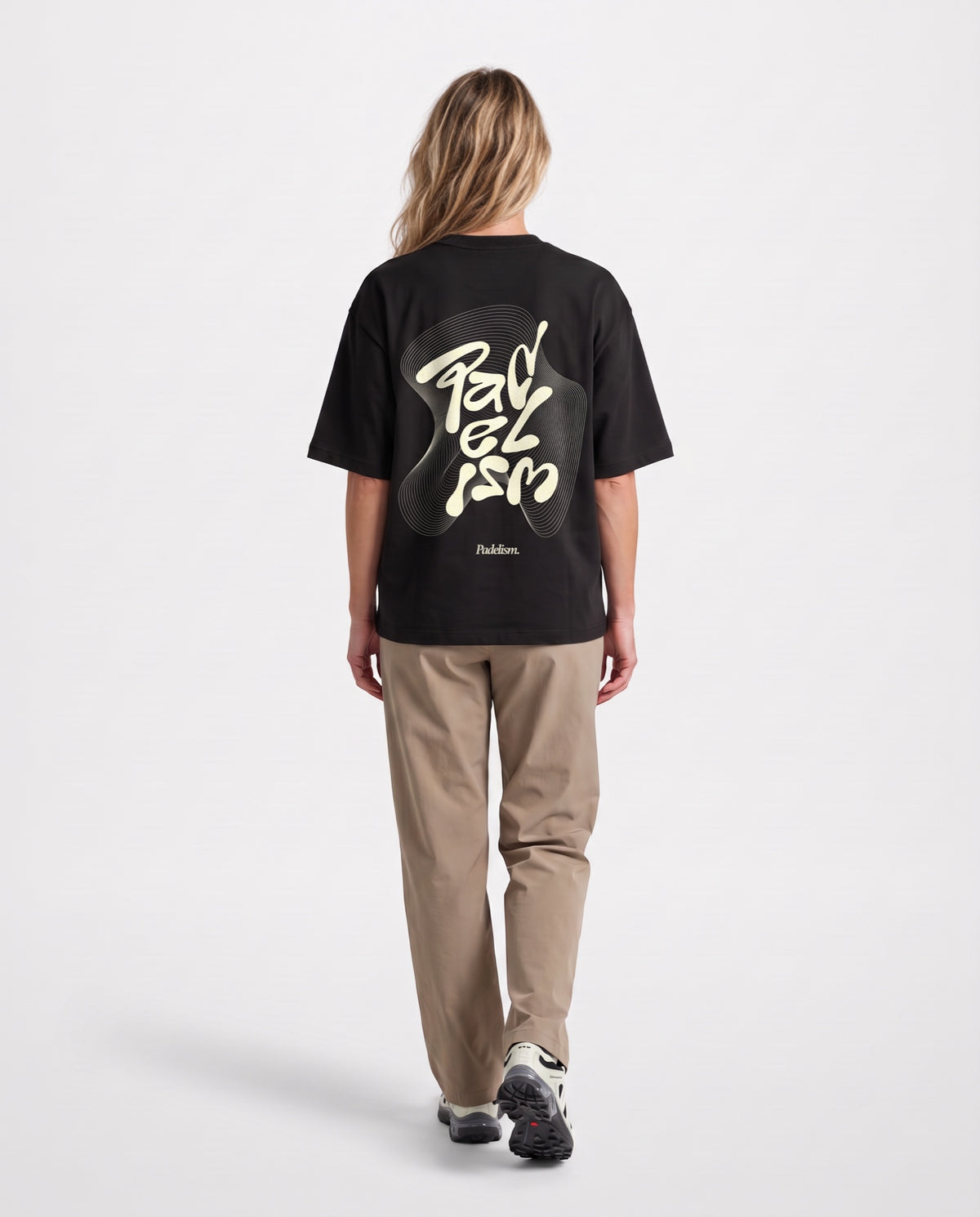 Flow - Heavyweight T-Shirt in Black, worn on model, woman, back walk