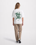 Flow - Heavyweight T-Shirt in White, worn on model, woman, back walk