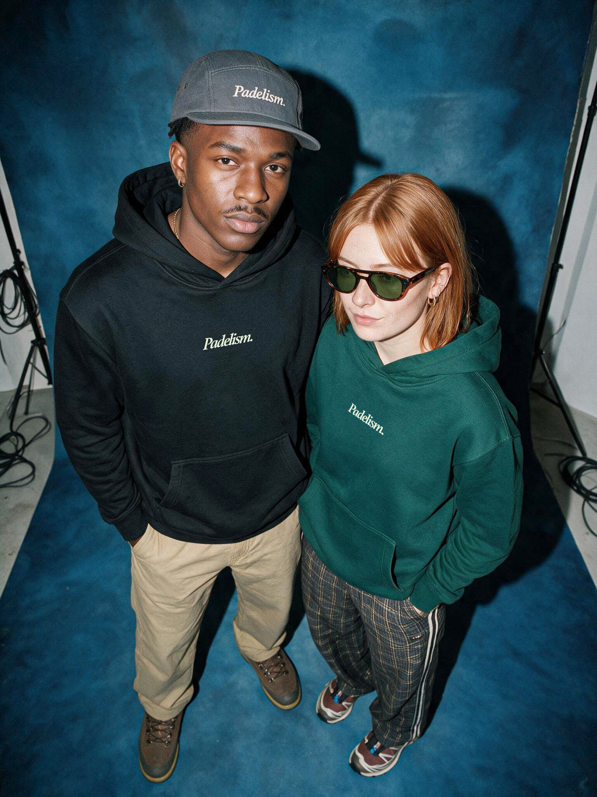 Two models in Black and Eden Green Padelism Mk1 Box Hoodies