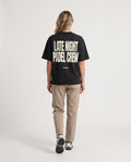 LNPC - Heavyweight T-Shirt in Black, worn on model, woman, back walk