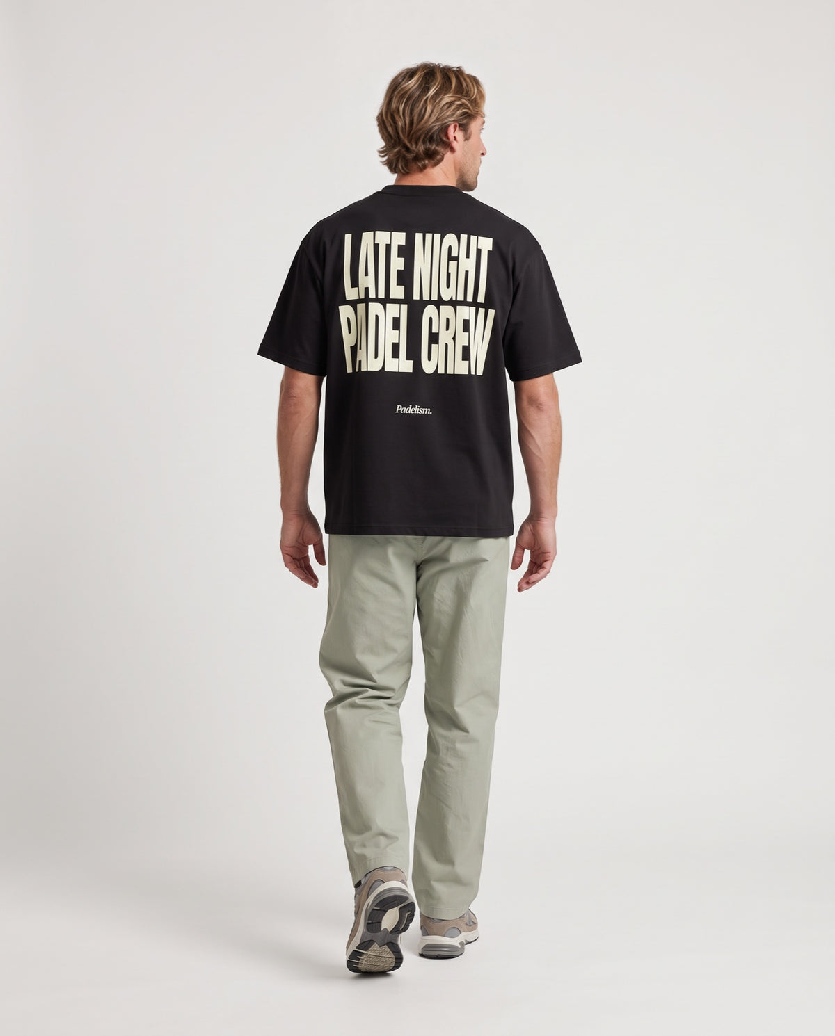 LNPC - Heavyweight T-Shirt in Black, worn on model, man, back walk