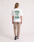Love - Heavyweight T-Shirt in White, worn on model, woman, back walk