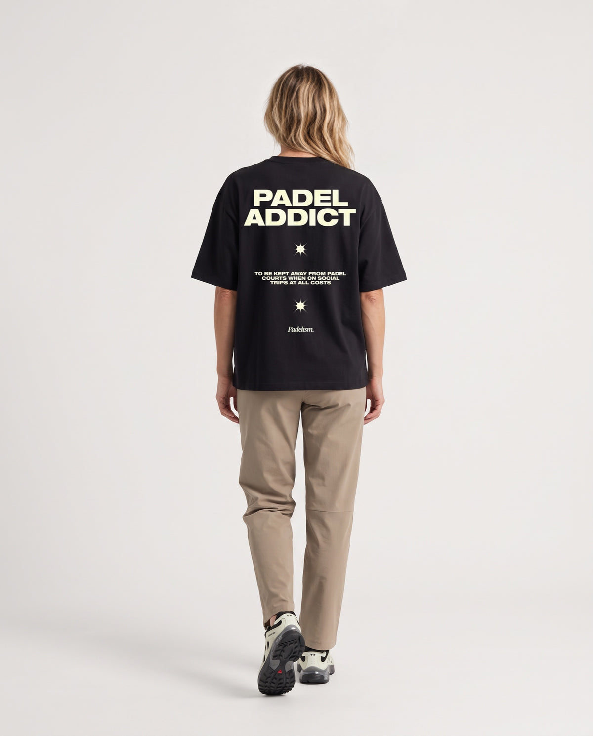 Padel Addict - Heavyweight T-Shirt in Black, worn on model, woman, back walk