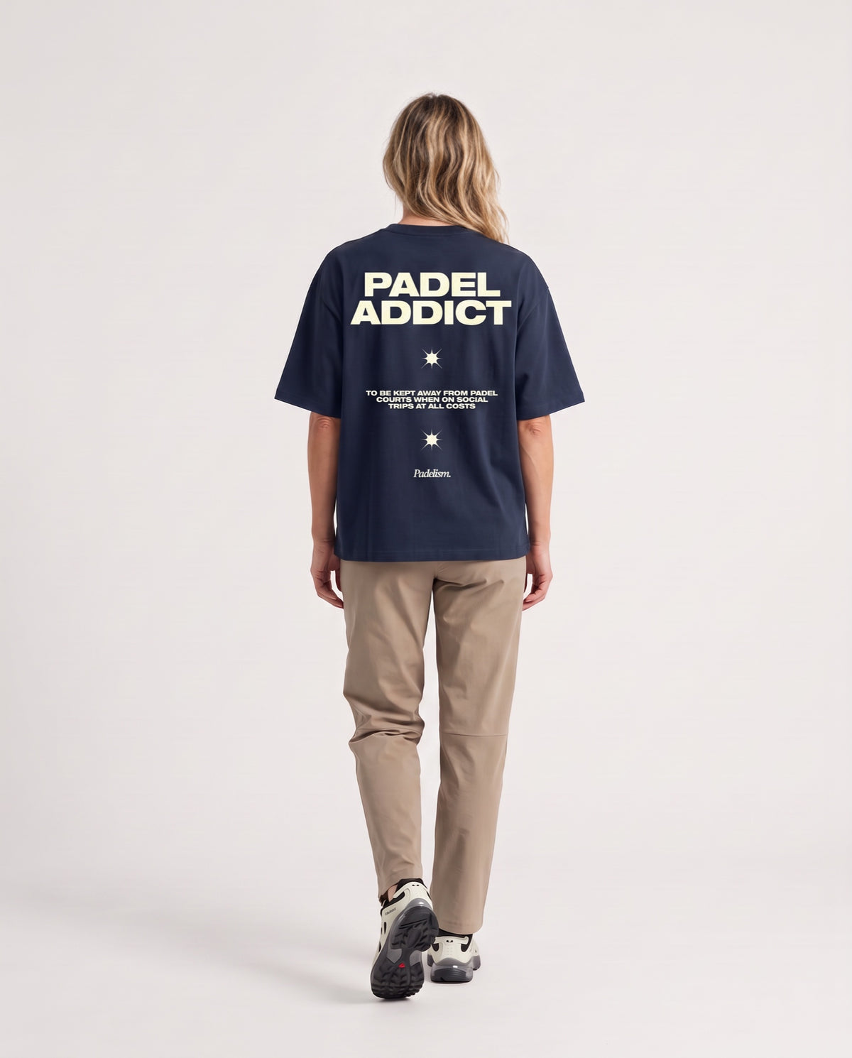 Padel Addict - Heavyweight T-Shirt in Navy, worn on model, woman, back walk