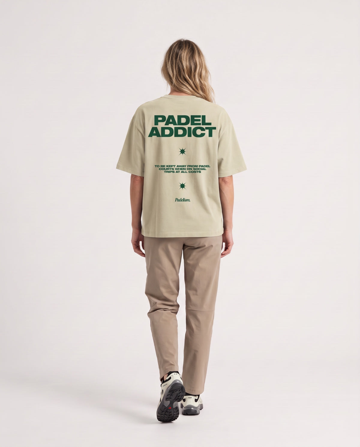 Padel Addict - Heavyweight T-Shirt in Sand Color, worn on model, woman, back walk