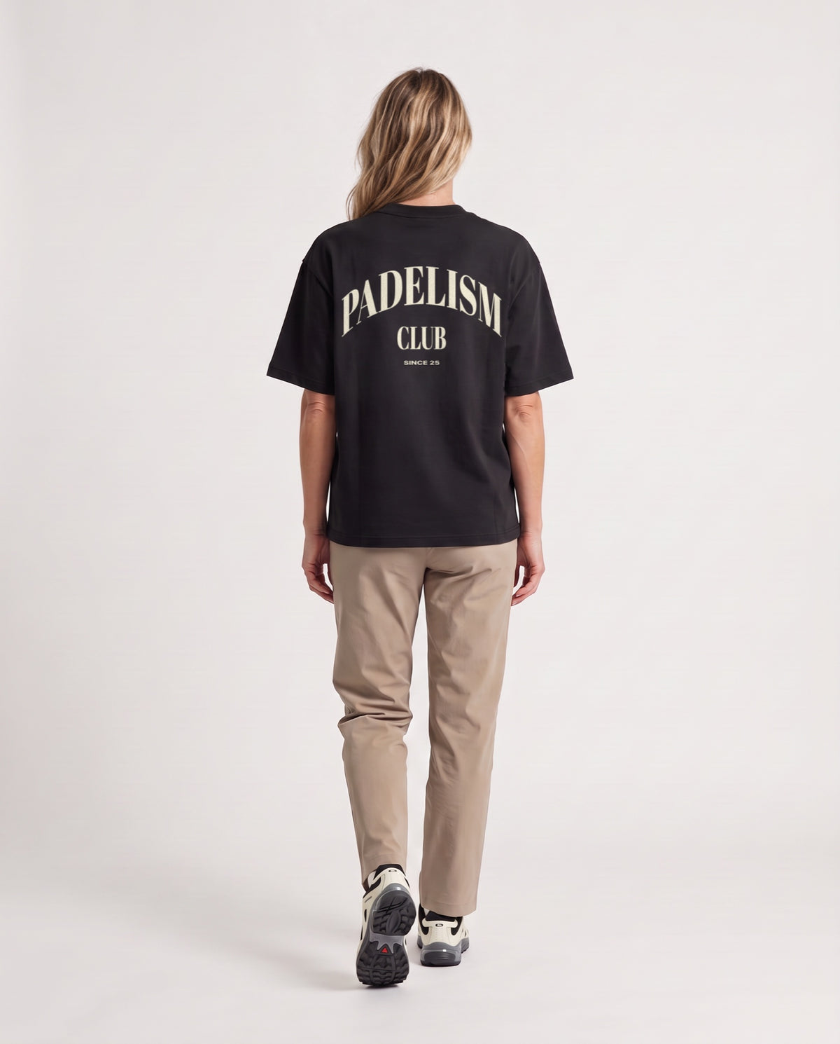 Padelism Club 25 - Heavyweight T-Shirt in Black, worn on model, woman, back walk