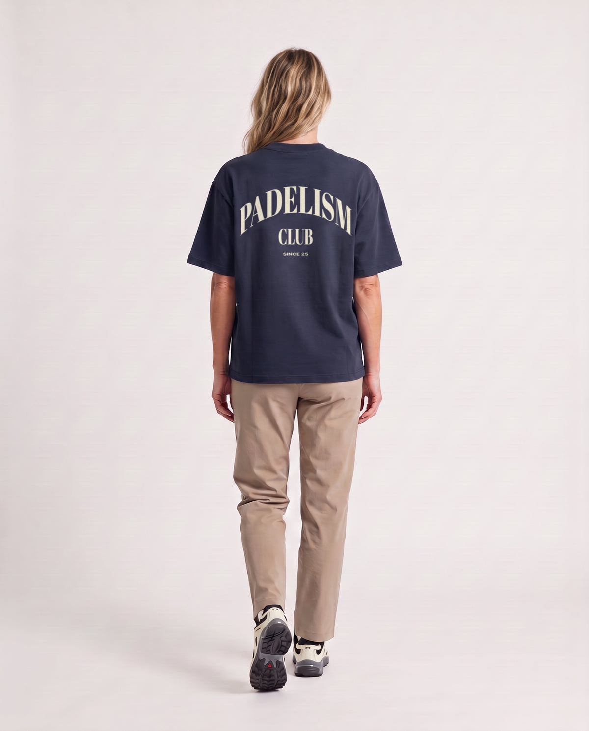 Padelism Club 25 - Heavyweight T-Shirt in Navy, worn on model, woman, back walk