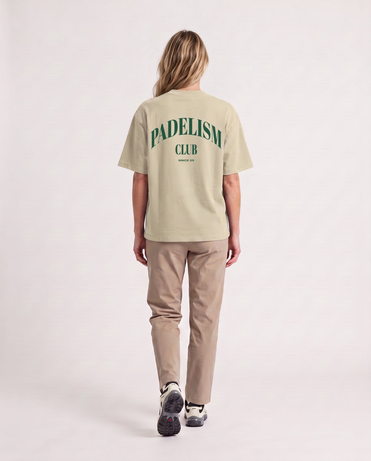 Padelism Club 25 - Heavyweight T-Shirt in Sand Color, worn on model, woman, back walk