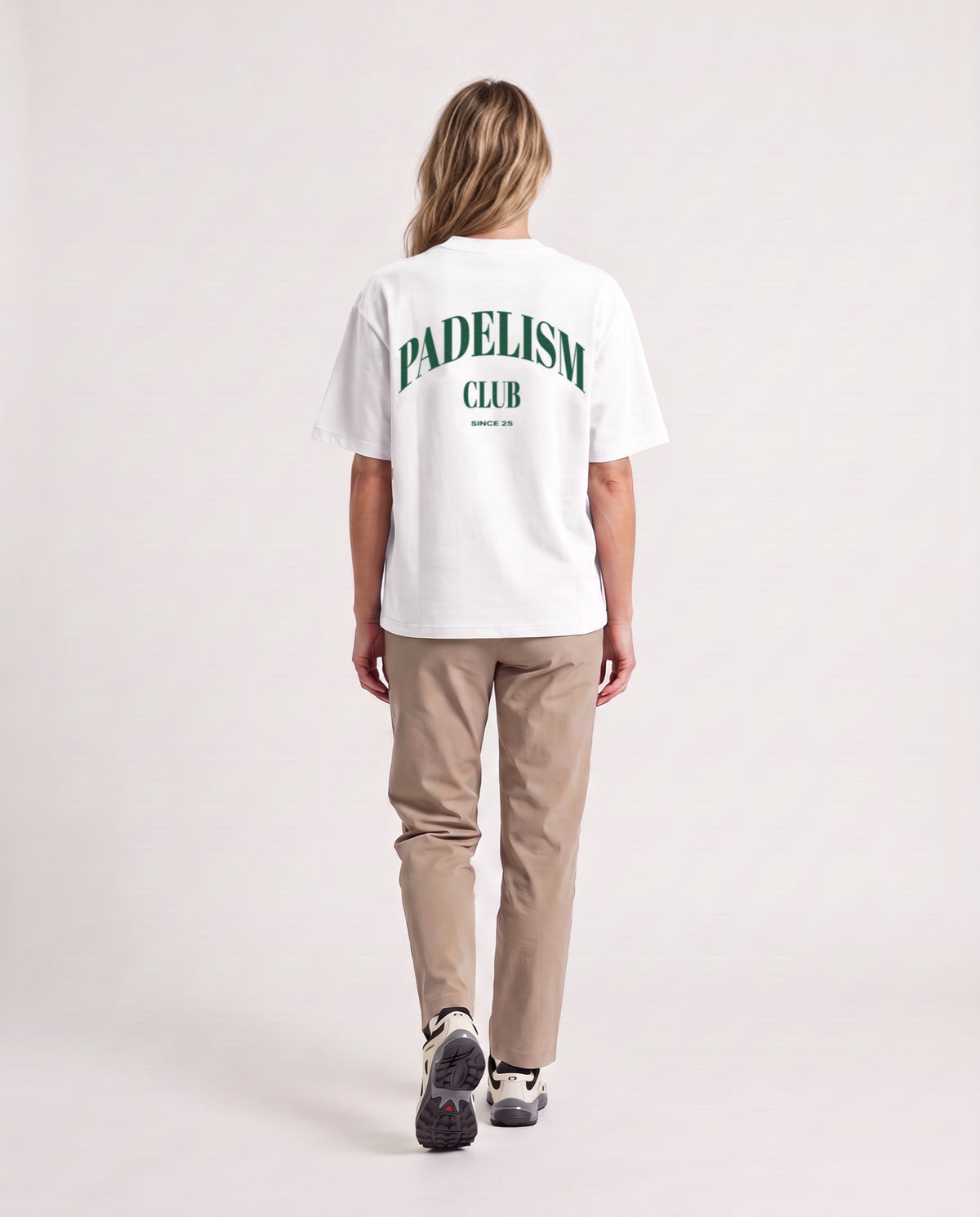 Padelism Club 25 - Heavyweight T-Shirt in White, worn on model, woman, back walk