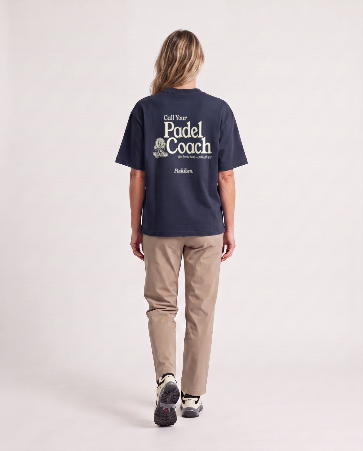 Padel Coach - Heavyweight T-Shirt in Navy, worn on model, woman, back walk