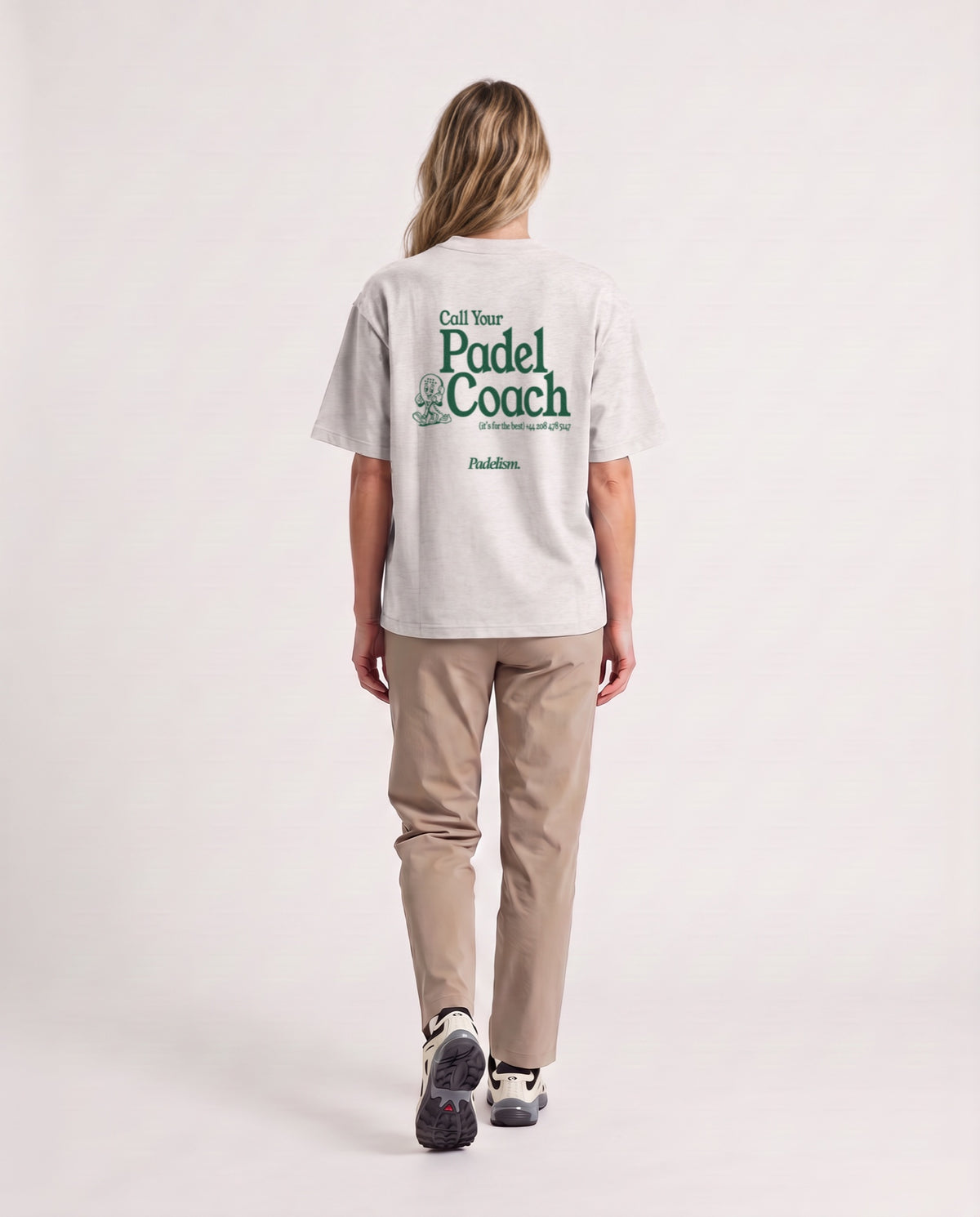Padel Coach - Heavyweight T-Shirt in Oat Gray, worn on model, woman, back walk