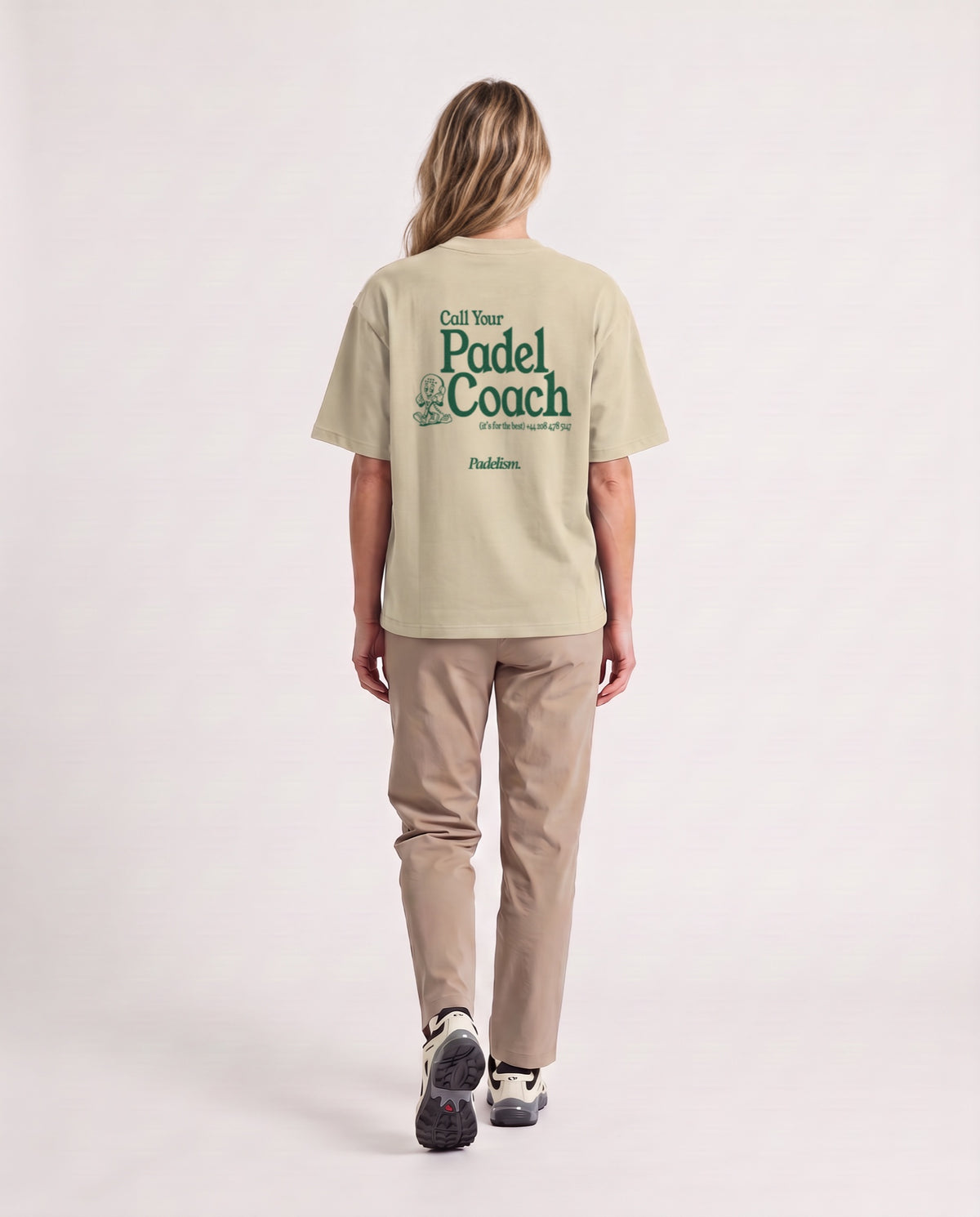 Padel Coach - Heavyweight T-Shirt in Sand Color, worn on model, woman, back walk