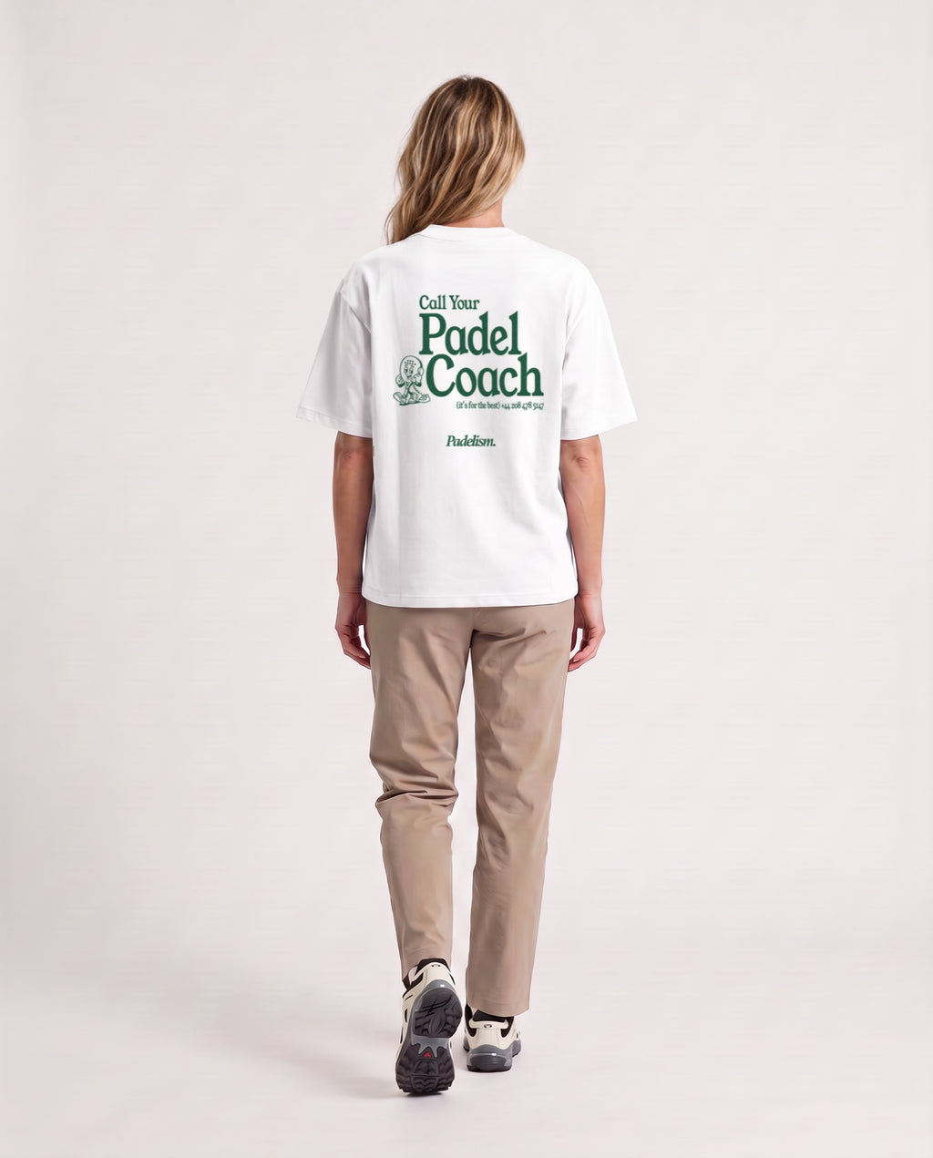Padel Coach - Heavyweight T-Shirt in White, worn on model, woman, back walk