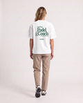 Padel Coach - Heavyweight T-Shirt in White, worn on model, woman, back walk