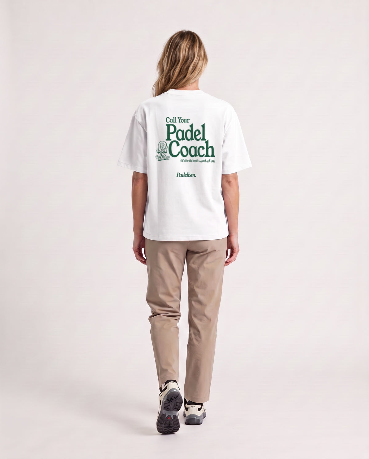Padel Coach - Heavyweight T-Shirt in White, worn on model, woman, back walk